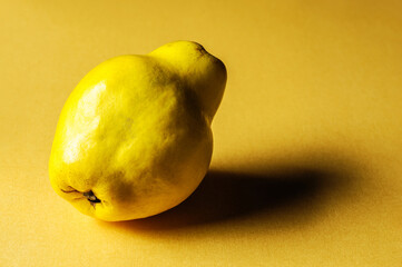 Quince On Yellow Background