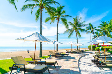 Beautiful umbrella and chair around swimming pool in hotel and resort