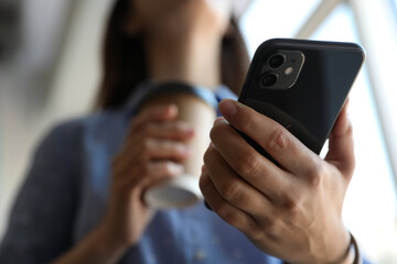 MYKOLAIV, UKRAINE - MARCH 16, 2020: Woman holding iPhone 11 Black indoors, closeup