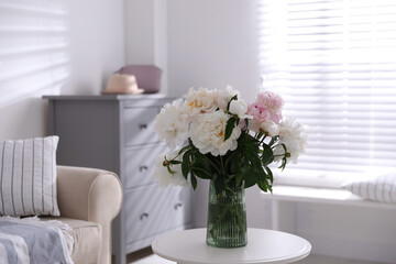 Bouquet of beautiful peony flowers on table indoors