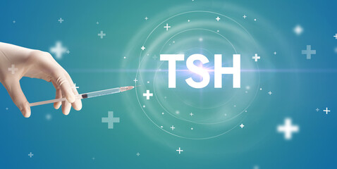 Obraz na płótnie Canvas Syringe needle with virus vaccine and TSH abbreviation, antidote concept