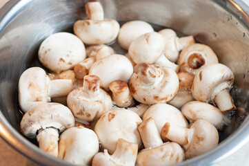 Porcini mushrooms are clean in the water in the kitchen