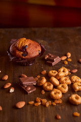 Chocolate maffin on a wooden table with chocolate and tartallini