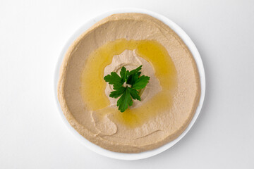 Hummus. A dish of crushed chickpeas for delivery, or  online store. Isolated on a white background.