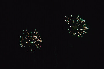 The green pyrotechnic volley in the night sky is very beautiful and causes delight.