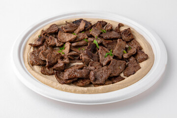 Hummus with beef . A dish of crushed chickpeas for delivery, or  online store. Isolated on a white background.