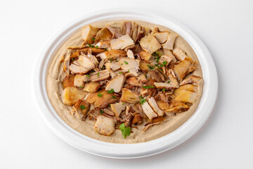 Hummus with chicken. A dish of crushed chickpeas for delivery, or  online store. Isolated on a white background.