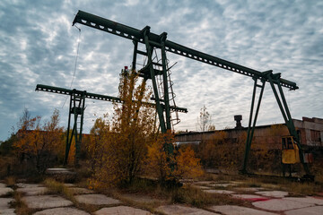 Old rusty gantry bridge crane in abandoned industrial area