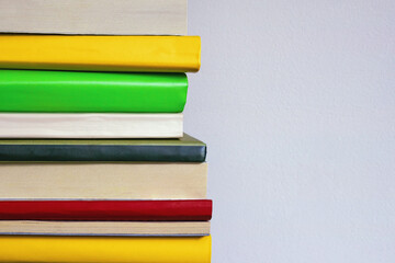 Vertical stack of colorful books. Free space for text