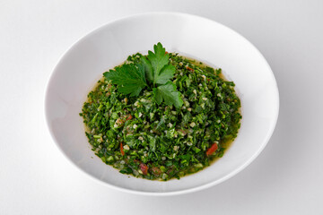 Salad of finely chopped herbs with sauce top view. Dishes for delivery, online store. Isolated on a white background.