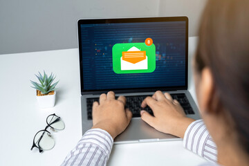 Person using a laptop computer with email communication connection message online and chat on social media with global letters concept.