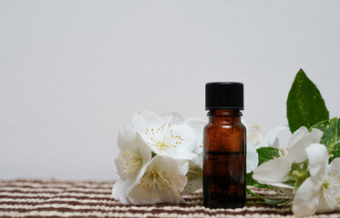 Spa still life with essential oil and white jasmine flowers 