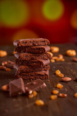 Chocolate cakes stacked on a wooden table. blurred background