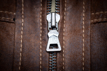 Zip fastener on a brown leather motorcycle jacket