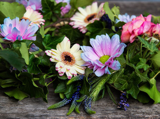 Flower crown pink gerbera, roses, ivy, blue flowers Old wooden table