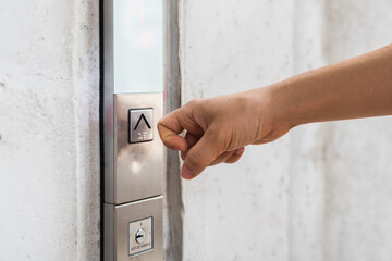 woman using finger to push button of lift. Corona virus prevention concept