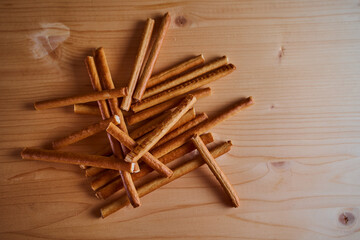 Bread sweet sticks on a wooden light board. Top view.