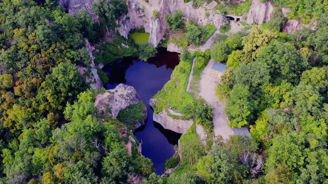 Flooded ancient stone quarry in Hungary near Sarospatak: Megyer-hegyi tengerszem. Small lake at the top of a hill. View from the top. Fantastic nature attraction in Tokaj area. 