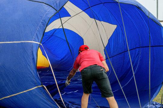 Worker preparing ballon for competition. Spain, Igualada, European Festival Balloon.