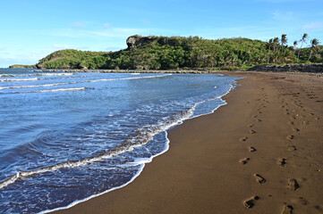 The Black Sand Beach of Talofofo bay on Guam. - obrazy, fototapety, plakaty