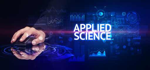 hand holding wireless peripheral with APPLIED SCIENCE inscription, modern technology concept