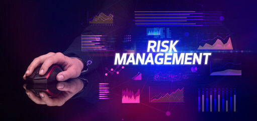 hand holding wireless peripheral with RISK MANAGEMENT inscription, cyber business concept