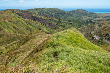 Lush grass fields on the southern ridges of Guam from the top of mount Lamlam.