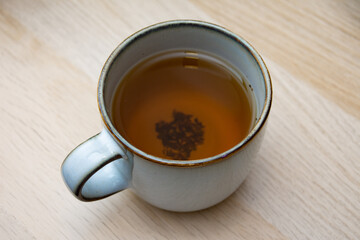 Herbal tea with tea leaves at the bottom of the mug
