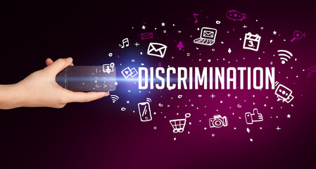 hand holding wireless peripheral with DISCRIMINATION inscription, social media concept