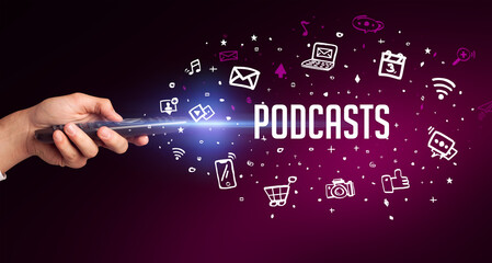 hand holding wireless peripheral with PODCASTS inscription, social media concept
