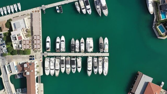 LIMASSOL, CYPRUS - JUNE 3, 2020: Boats docked in the Limassol Marina on a morning. Aerial footage