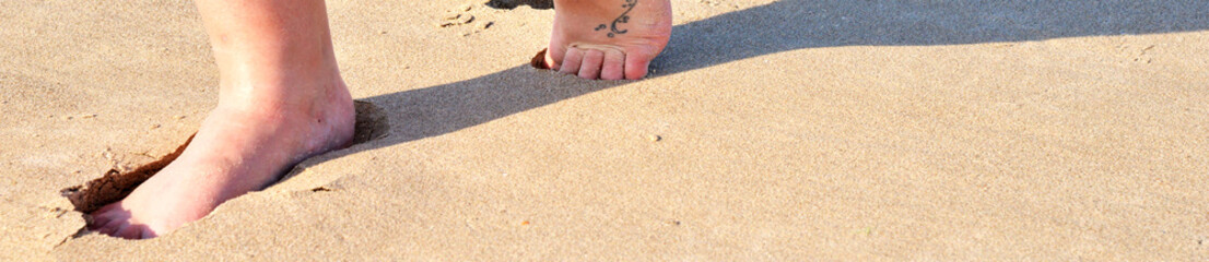 Walking on the beach while on holiday in the UK, Cumbria, England, UK