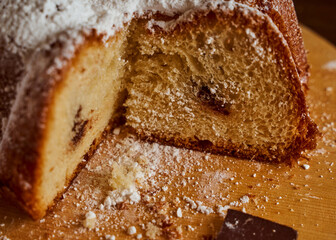 Cut homemade cupcake with chocolate cream inside on a wooden board. Close-up.