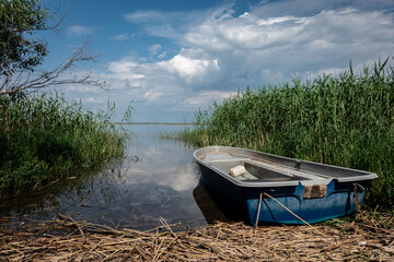 Obraz premium A lonely boat on the shores of the lake Lubana. Lubana Lake is the largest lake in Latvia.