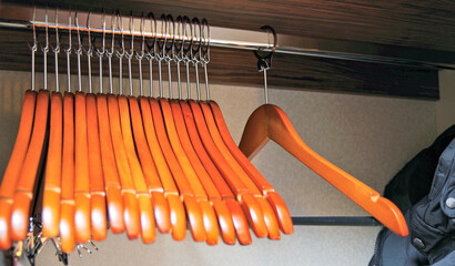 Wooden hangers inside closet in cabin or stateroom of luxury cruiseship or cruise ship liner