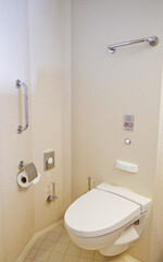 Clean and modern design bathroom with sink, shower, bath tub, towels and mirror and mosaic tiles in...