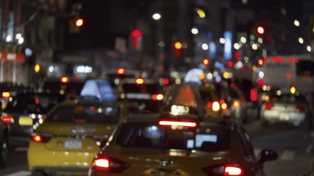 NYC congested busy street traffic by night, unrecognizable commuting cars
