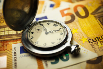Time is money concept with euros banknotes.