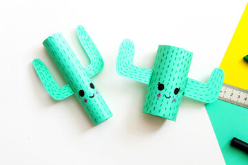 Step-by-step lesson: how to make a cute cactus from a toilet sleeve and colored paper. Using scissors and glue. Step 9 - Close-up. Interesting crafts with children.