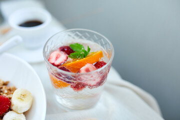 Summer cocktail with strawberry, orange and mint in glass