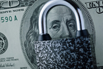 Padlock on dollar bill on portrait of Franklin