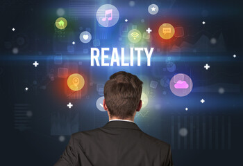 Rear view of a businessman with REALITY inscription, modern technology concept