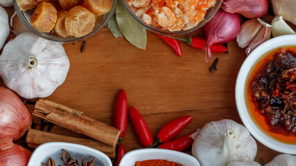  Spices and ingredients for Asian cooking on a wooden platter