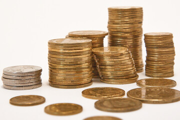 Stacks of coins on a white background.