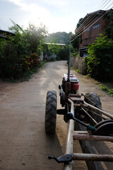 Obraz premium Tractor car is used to plow in rice field at countryside of Thailand