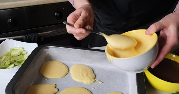 Preparation Of Chocolate And Vanilla Cake. Close Up. Woman Spreads Sponge Cake On A Baking Sheet. Black And White Dough Combination. Spicy Rhubarb Adds Flavor. Dessert For Coffee Or Tea. Yellow. 