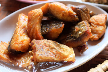 Deep fried Snapper with fish sauce on white dish