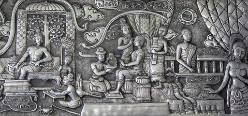 Detail of aluminium and silver bas-relief with stories of Buddhism, dharma puzzles, and the history of the Wat Sri Suphan, or silver temple in Chiang Mai, kingdom Thailand