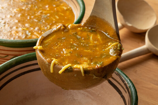 Wooden tablespoon with Moroccan harira close up