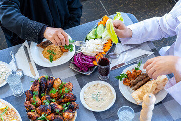 happy muslim family eating togther